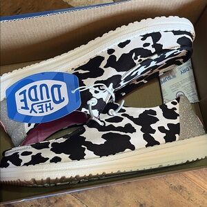 Hey Dude Black and White Cow Print Slip-Ons